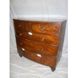A Victorian figured mahogany bow front chest of two short and three long drawers with turned