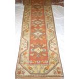 An Eastern style wool runner with geometric decoration on red & cream ground