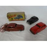 A boxed Chad Valley remote controlled car with accessories and two similar un-boxed clock-work cars