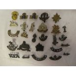 A selection of original Military cap badges and insignia including Warwickshire I.Y.