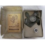 A Second War German civilian gas mask in original box with instructions