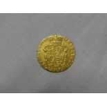 A George III 1775 gold guinea with shield back (brooch marks)