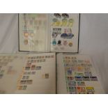 Three stock books containing a collection of World Stamps including Fiji, Tonga, Bermuda, Uruguay,