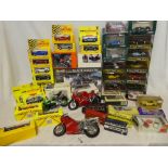 A large selection of various boxed and un-boxed die cast vehicles together with motorcyles,