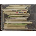 A box containing First Day covers including GB, Guernsey, Jersey,