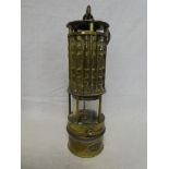 An unusual brass Miner's lamp by Wolf Safety Lamp Co of America with cylindrical lens and swing