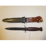 A United States M8A1 Survival knife in composition and leather sheath