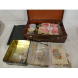 A box containing various stamps in packets, covers,