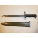 A United States Army bayonet with single edged blade in composition and steel scabbard