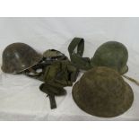 Three various Military steel helmets, selection of various belts,