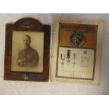 A leather mounted photo frame with applied Royal Warwickshire and Artists Rifles badges and an