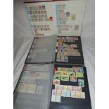 Three stock books containing a collection of stamps including Japan, Vietnam, Afghanistan, Thailand,