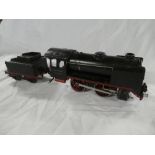 A Marklin O gauge 0-4-0 clockwork locomotive and tin plate tender