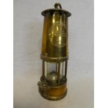 An all-brass Miner's lamp by the Protector Lamp & Lighting Co Ltd