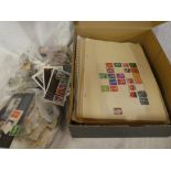 A box containing various packets of GB and World stamps