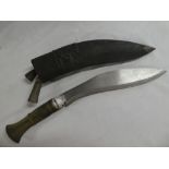 A Ghurka Kukri knife with curved single edged blade and horn hilt in leather sheath