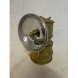 A small brass Cornish Premier Acetlyne Miner's lamp with circular reflector