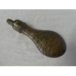 A 19th Century brass mounted copper powder flask by G & J W Hawksley with raised scroll decoration