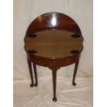 An early 19th Century mahogany semi-circular double opening turnover-top card and tea table with