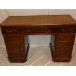 A Victorian walnut rectangular pedestal desk with three drawers in the frieze and six pedestal