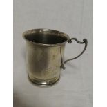 A George V silver circular christening tankard with scroll handle,