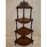 A mid Victorian inlaid burr walnut four-tier corner whatnot with turned supports and pierced