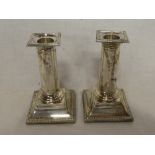 A pair of Edward VII silver column candlesticks with square shaped bases, 5" high,