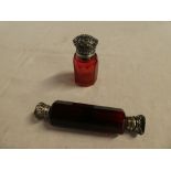 An Edward VII cranberry tinted glass scent bottle with silver mounted hinged lid,