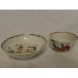 An 18th Century china tea bowl and saucer with painted Eastern figure decoration