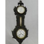 An old combination wall clock and aneroid barometer by J.J. Wainwright & Co.