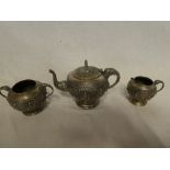 A good quality Indian silvered three-piece tea set comprising circular pedestal teapot with raised