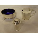 A George V silver three piece cruet set comprising oval salt with blue glass liner on tapered legs,