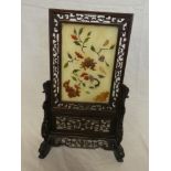 A Chinese rosewood table screen with inset soapstone rectangular panel decorated in relief with