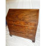 A George III mahogany bureau with internal drawers and pigeonholes enclosed by a fall front above