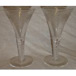 A pair of 19th Century glass wine glasses with etched tapered bowls and air twist stems,