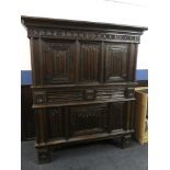 A large impressive 18th Century and later carved oak Baronial-style cupboard with two drawers in