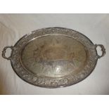 A large electro plated oval two handled tea tray with engraved decoration,