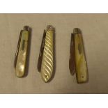 Three silver bladed folding fruit knives with mother of pearl mounts including folding knife,