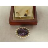 A gold mounted oval brooch set amethyst surrounded by pearls and a pair of amethyst mounted