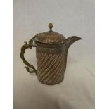 An old Middle Eastern copper and brass tapered coffee pot with hinged lid and raised decoration,