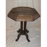An Eastern carved rosewood octagonal occasional table with pierced borders on four slender supports