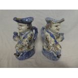 A pair of 19th Century French faience pottery Toby Jugs with painted floral decoration on powdered