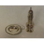 An Edward VII silver circular strainer with raised decoration and loop handle,