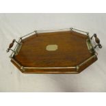 An Edwardian oak oval two-handled tea tray with silver-plated gallery and mounts