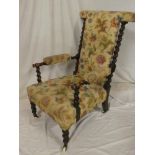 A late Victorian beech open arm easy chair upholstered with a floral fabric,
