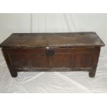 An 18th Century oak rectangular coffer with panelled front and hinged lid on block feet,