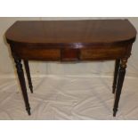 A mid 19th Century mahogany semi-circular turnover-top tea table with decorated frieze on turned