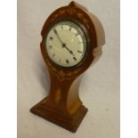 An Art Nouveau mantel clock with circular enamelled dial in inlaid mahogany arched tapered case,