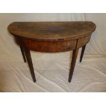 An early 19th Century mahogany semi-circular side table on square tapered legs