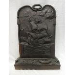 An unusual carved wood arched fire screen decorated with a central sailing ship,